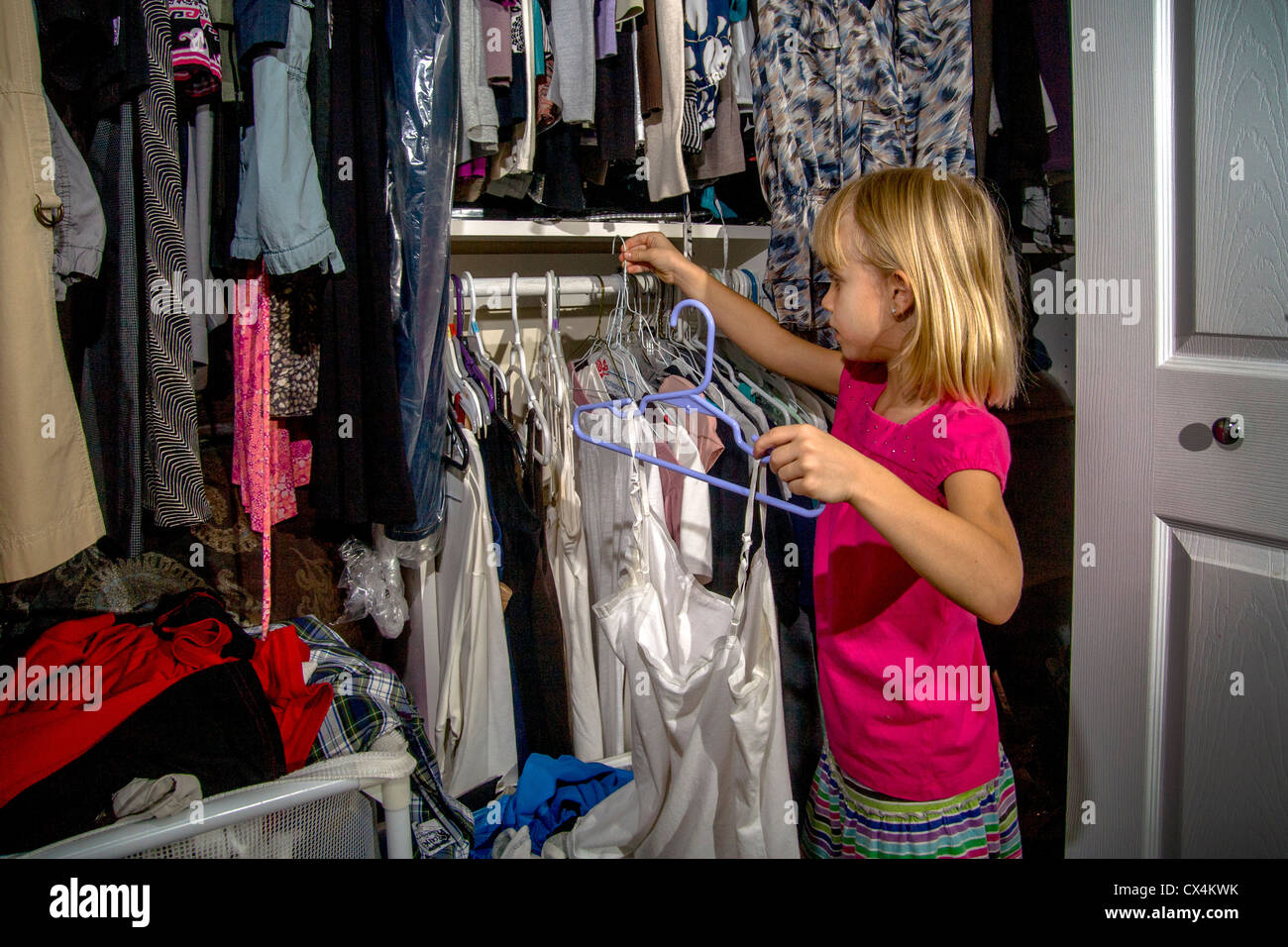 https://c8.alamy.com/comp/CX4KWK/helping-with-household-chores-a-seven-year-old-girl-hangs-clothes-CX4KWK.jpg