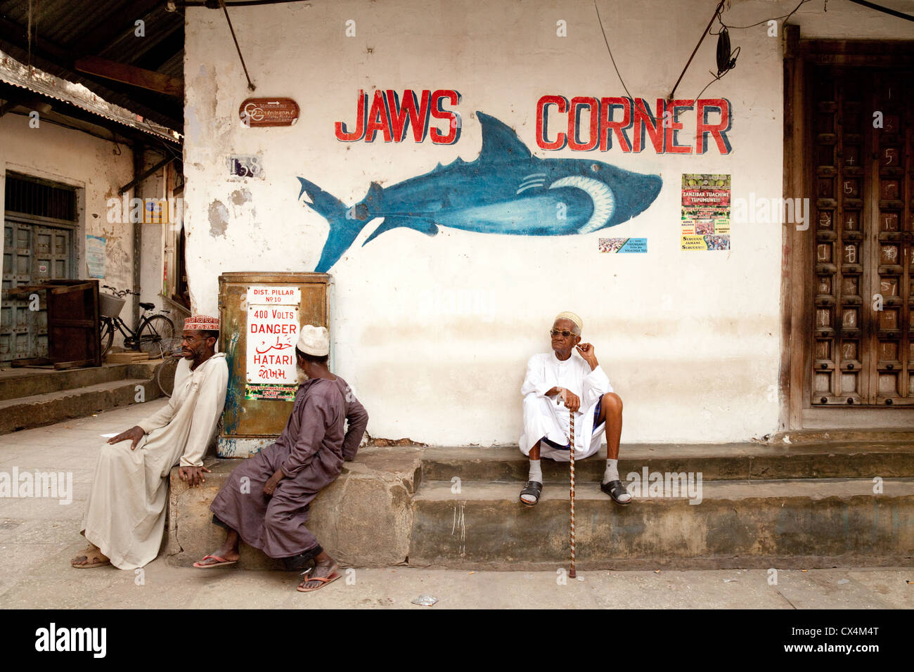 Local culture - people at Jaws Corner, where local people discuss politics, Stone Town, Zanzibar Tanzania Africa Stock Photo