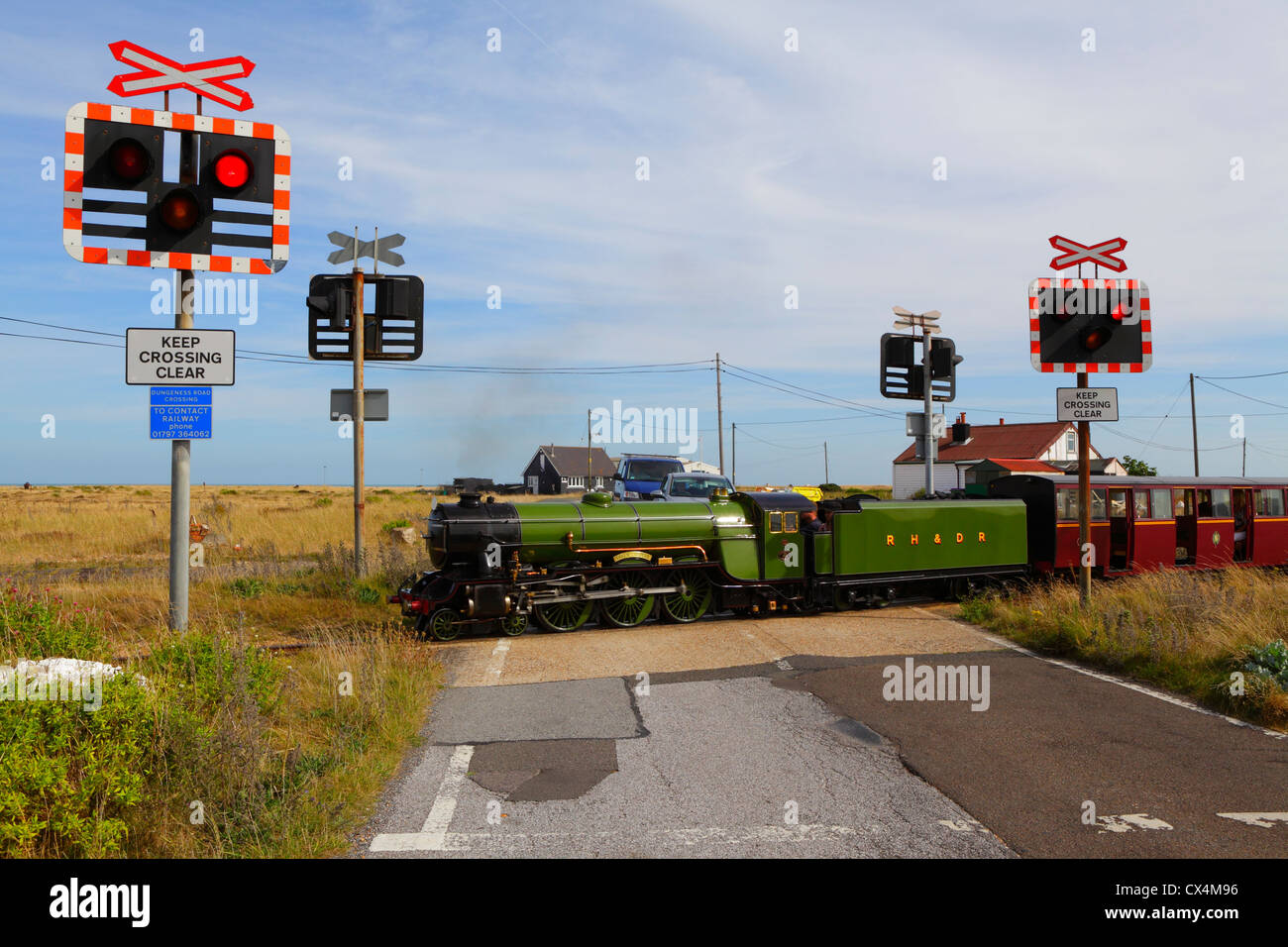 Romney Hythe and Dymchurch light railway train on crossing at Greatstone Dungeness Kent UK GB Stock Photo