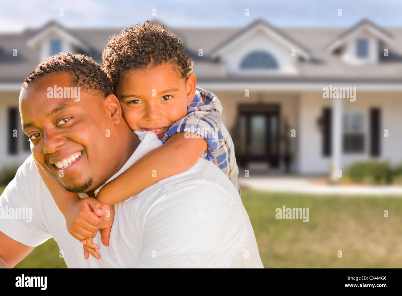 Happy Playful African American Father and Mixed Race Son In Front of ...
