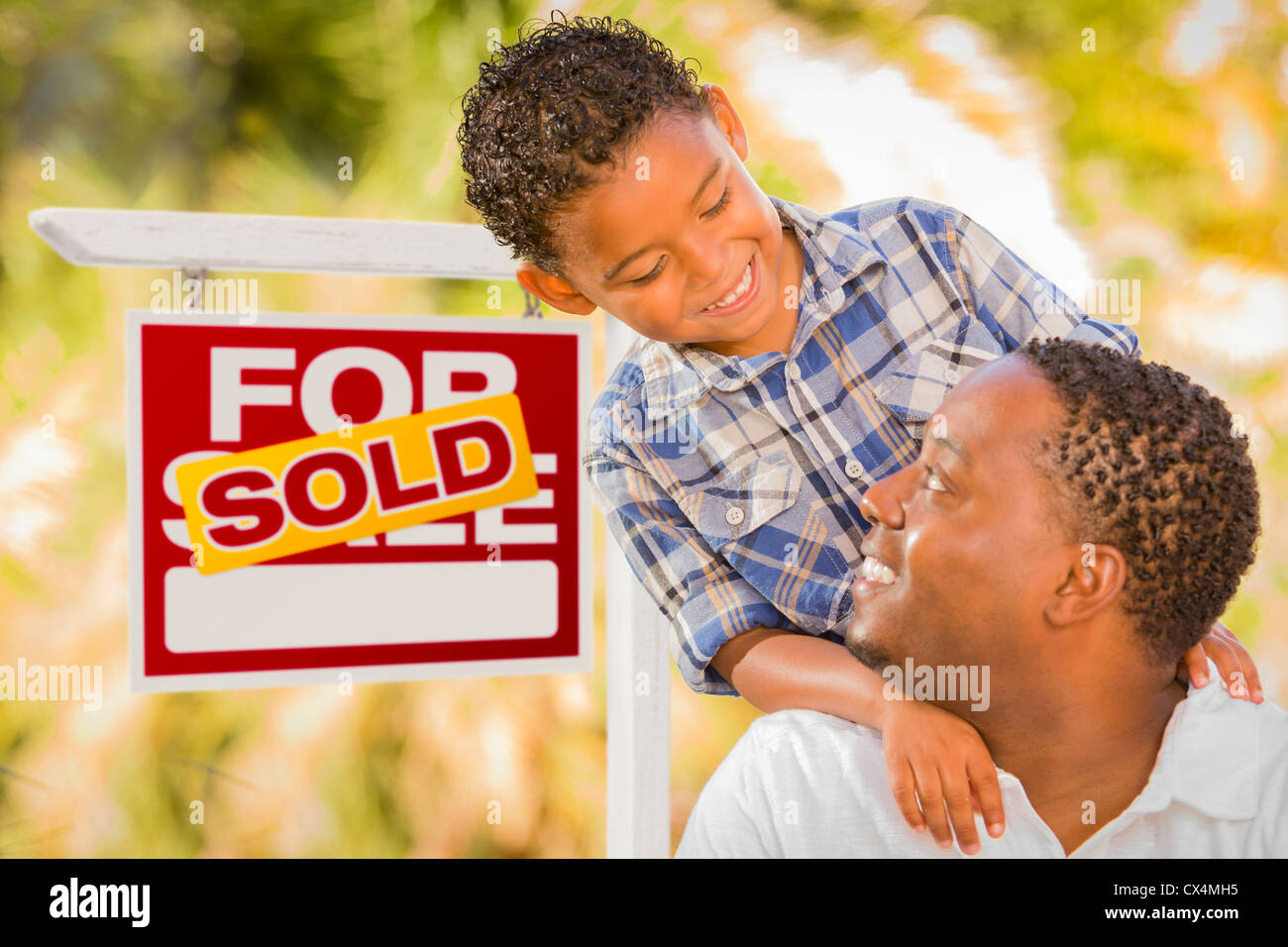 Happy African American Father and Mixed Race Son in Front of Sold Real ...
