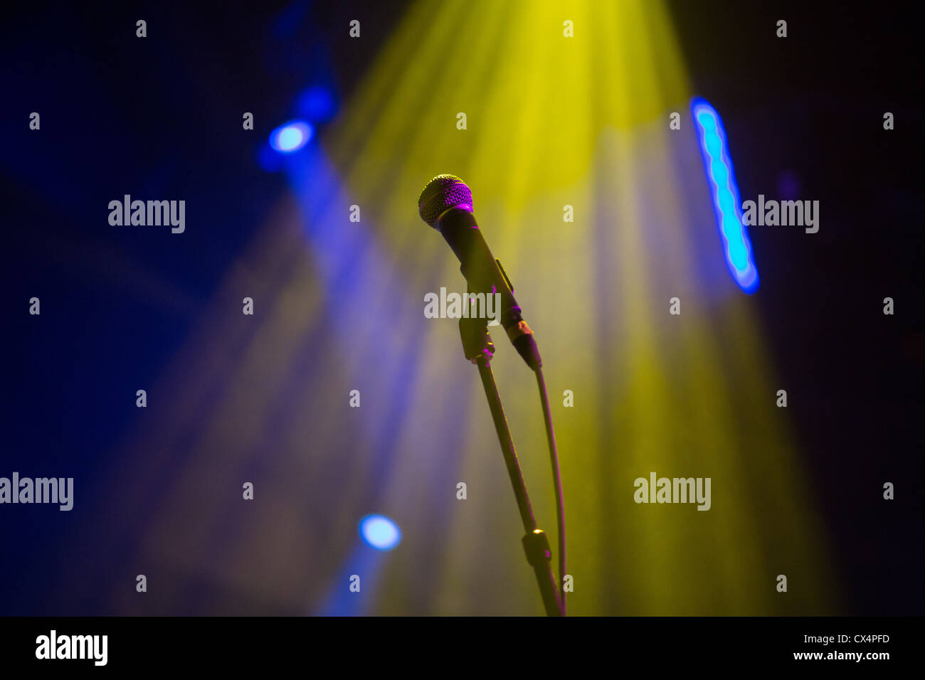 A microphone in the spotlight at a rock concert Stock Photo