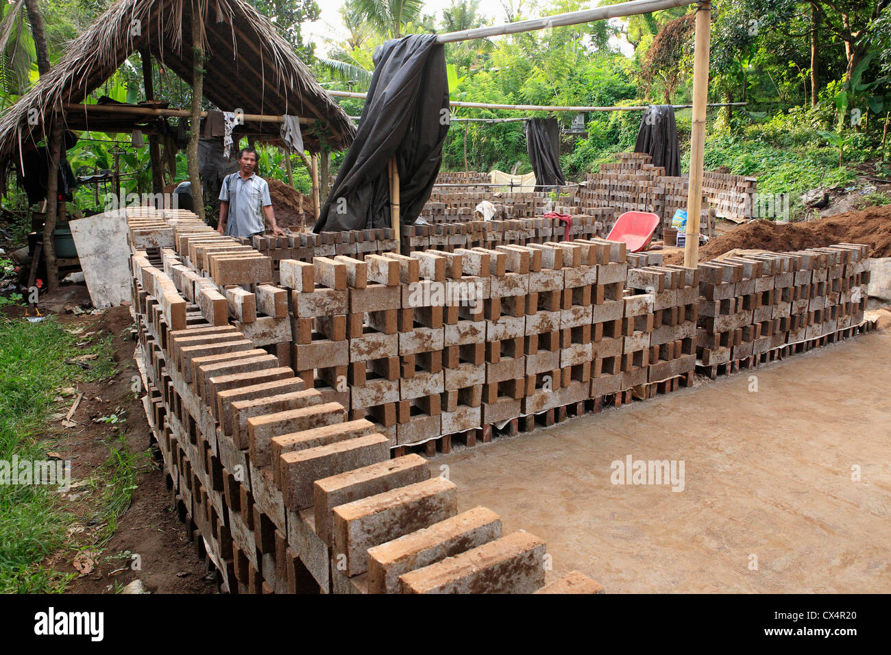 A factory for handmaking bricks, near Singaraja, north Bali, Indonesia. The bricks are made of clay, sun dried and then fired. Stock Photo
