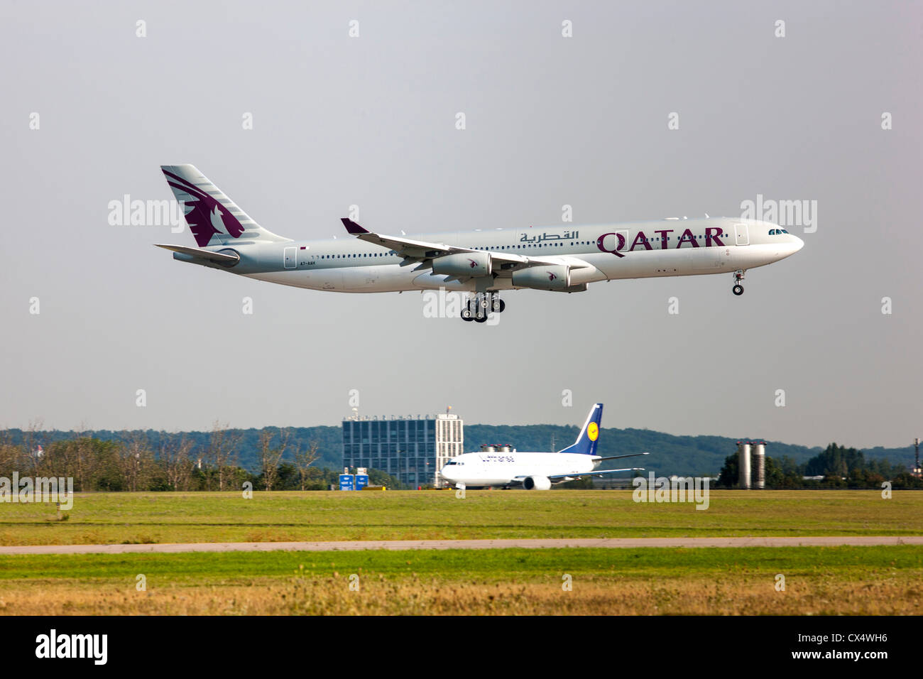 Passenger airplane approaching Düsseldorf International Airport. Qatar Airways, Airbus A340-313X, Germany Stock Photo
