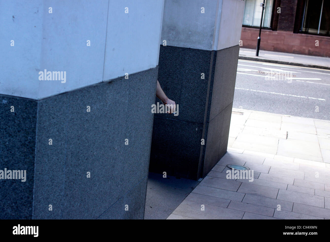 Office worker taking a cigarette break in The City of London Stock Photo