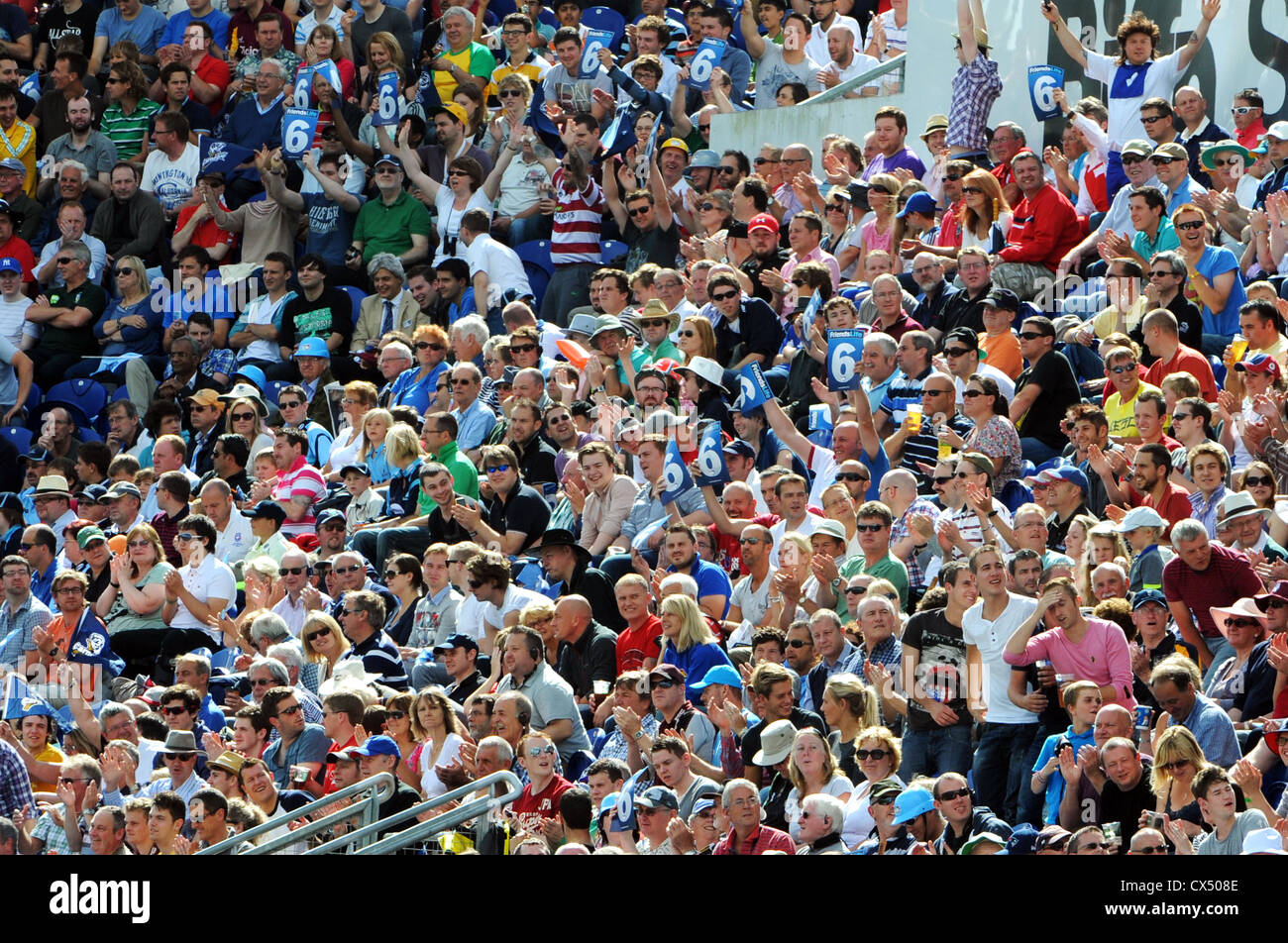 Cricket fans cheers and wave 6's during the Twenty20 Finals Day 2012 at the Swalec Stadium in Cardiff Stock Photo