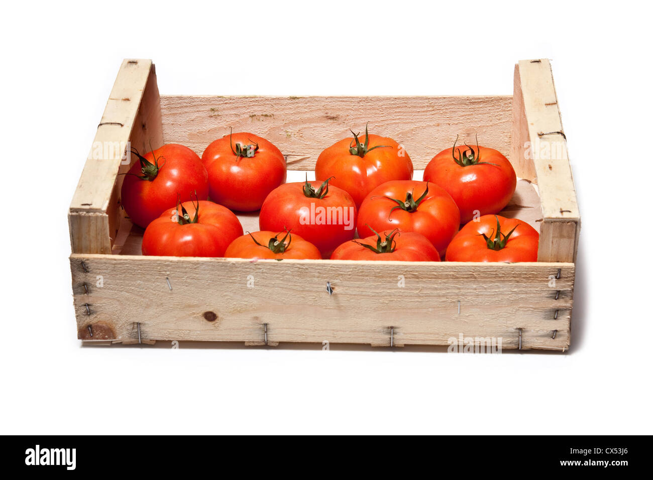Box of beef tomato's isolated on a white studio background. Stock Photo