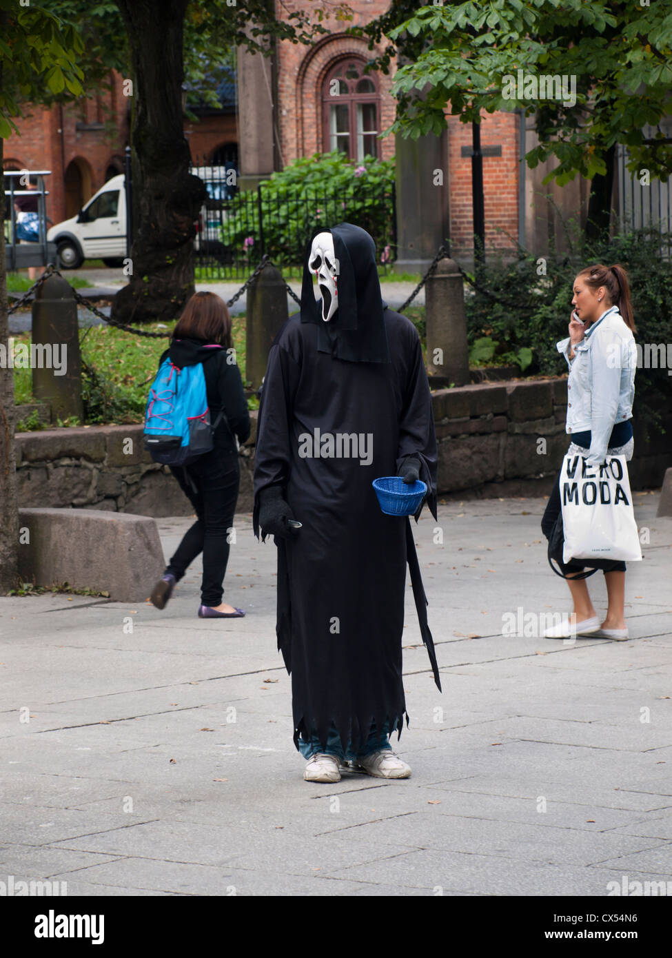 The scream by Edvard Munch has taken on a human form and is collecting money in Oslo`s parade street Karl Johans gate Stock Photo