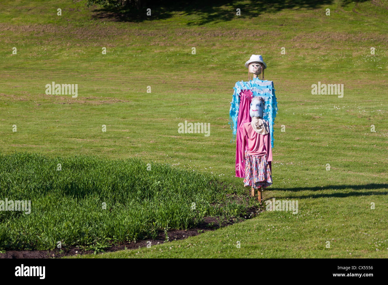 Two scarecrows stand together in the garden Stock Photo