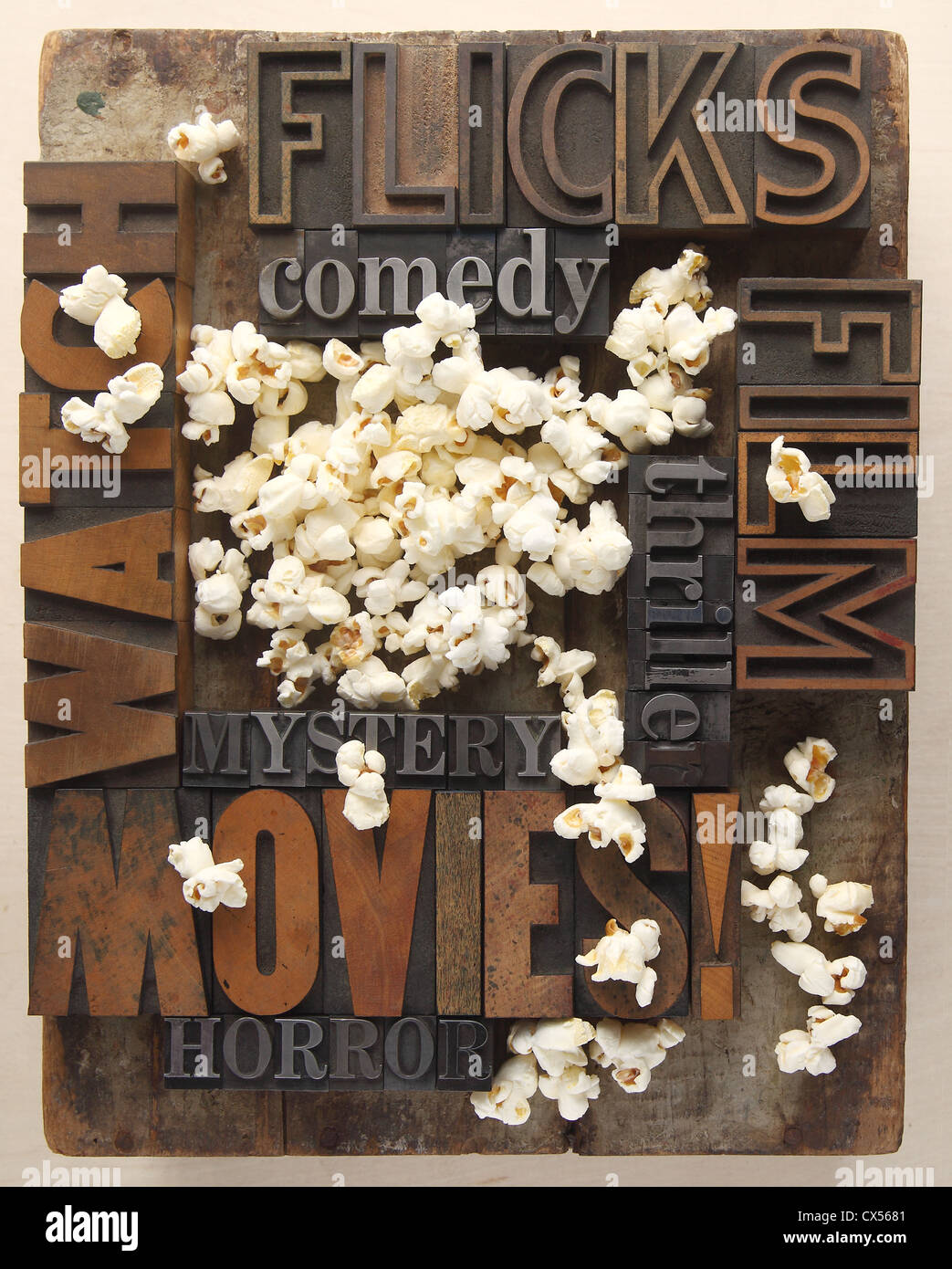 words associated with movie watching in old letterpress wood and metal type with popcorn Stock Photo