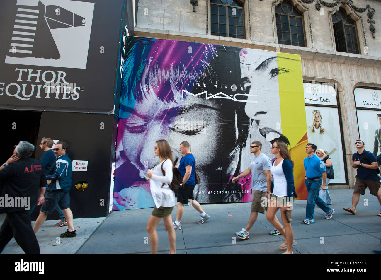 A billboard on a construction shed announces the future home of a MAC cosmetics store l Stock Photo