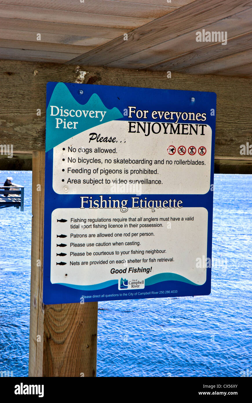 Sign fishing etiquette rules Discovery Passage Pier Campbell River BC Canada Stock Photo