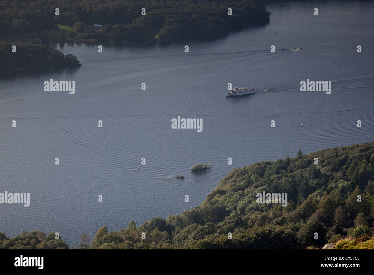 Sunlight reflecting on a pleasure boat on Windermere, as seen from