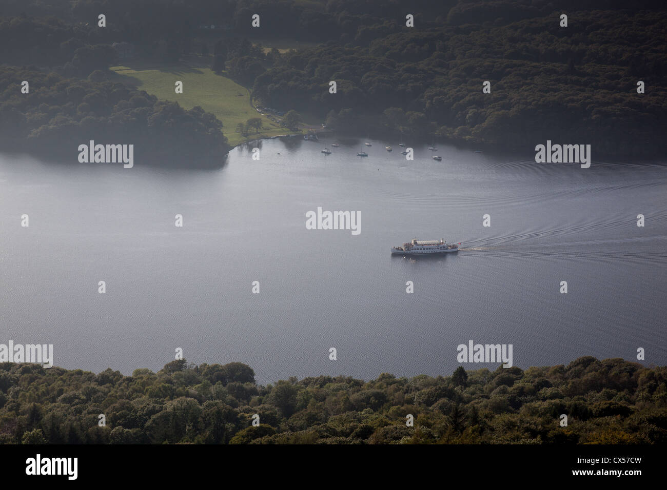 Sunlight reflecting on a pleasure boat on Windermere, as seen from