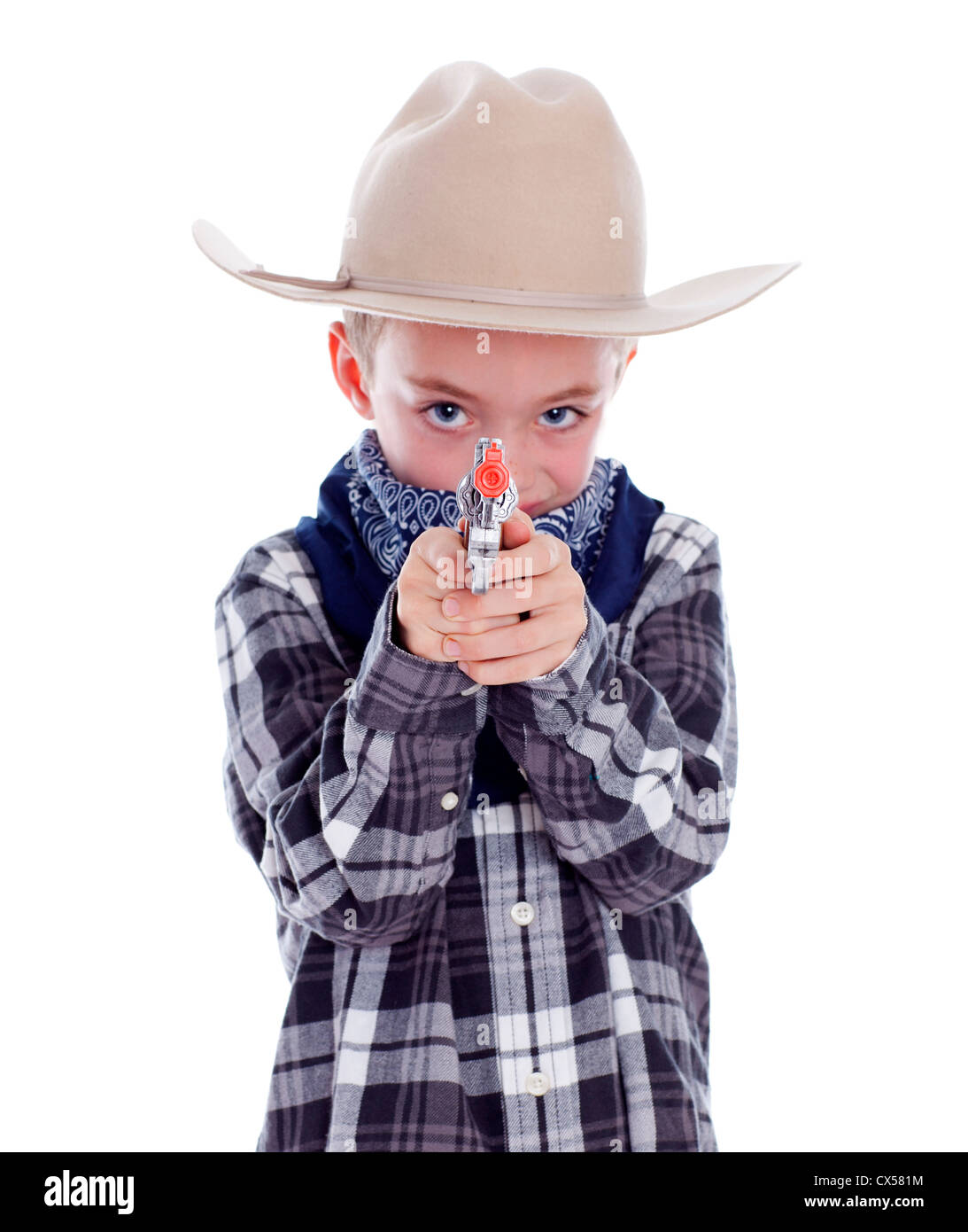 Young boy dressed as a cowboy with gun Stock Photo