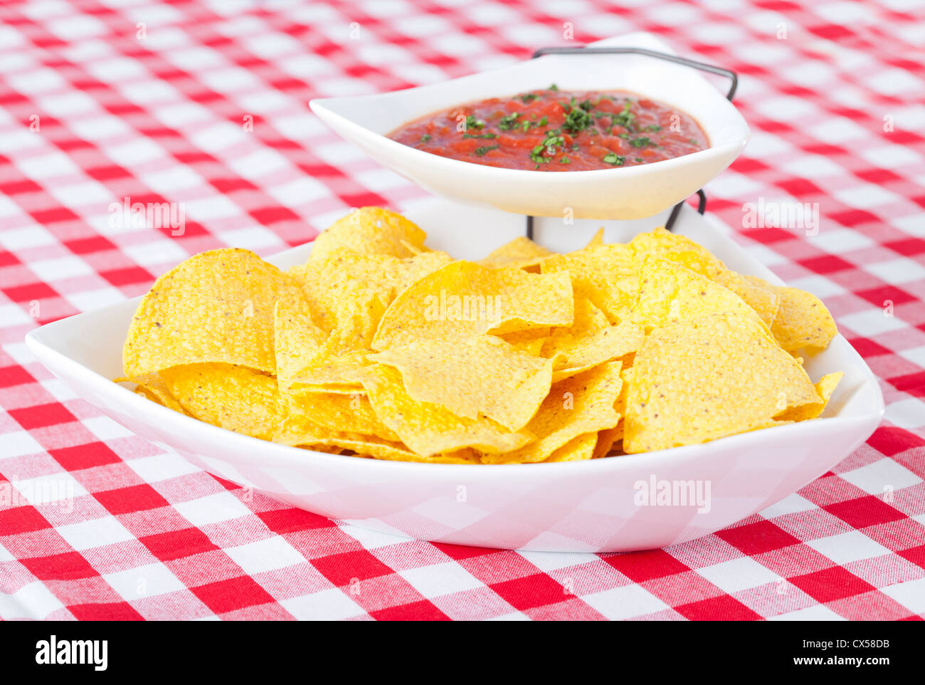 Chips and salsa on checkered tablecloth Stock Photo