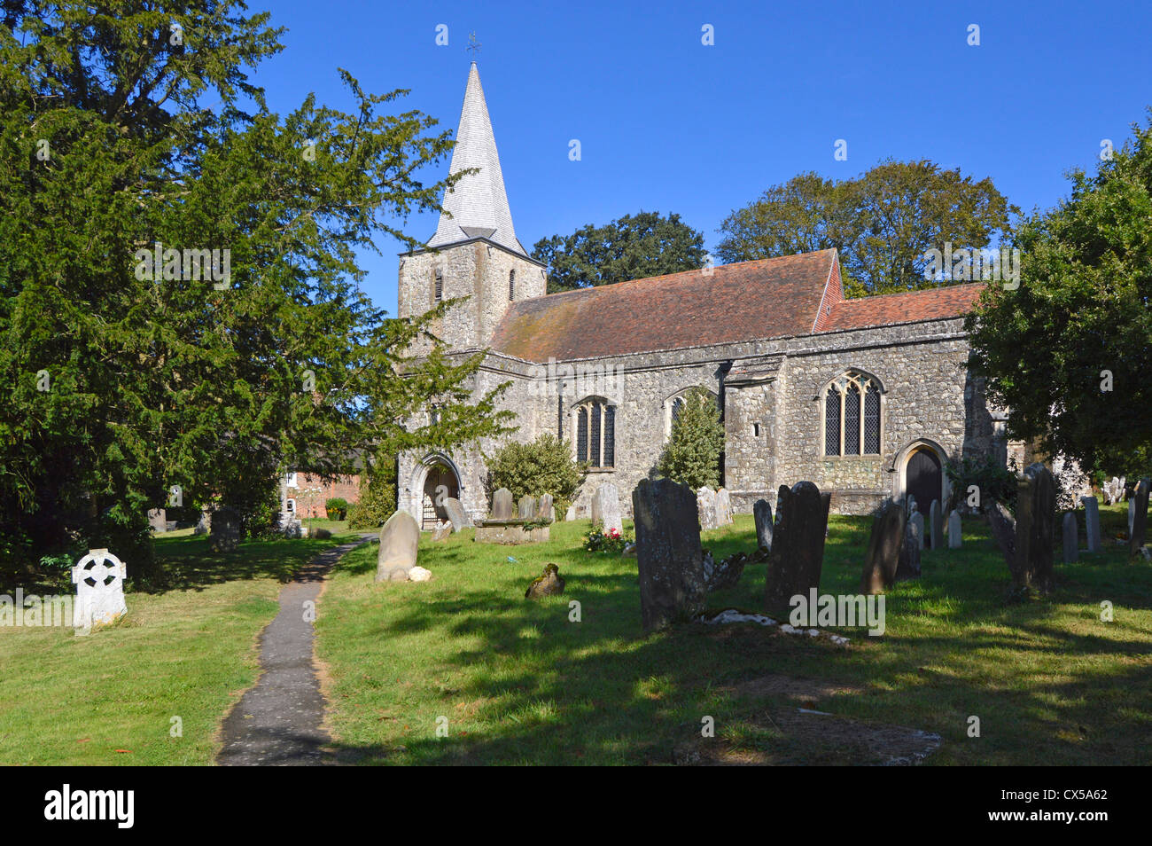 Saint Nicholas parish church and graveyard in the village of Pluckley and featured in TV series The Darling Buds of May Stock Photo
