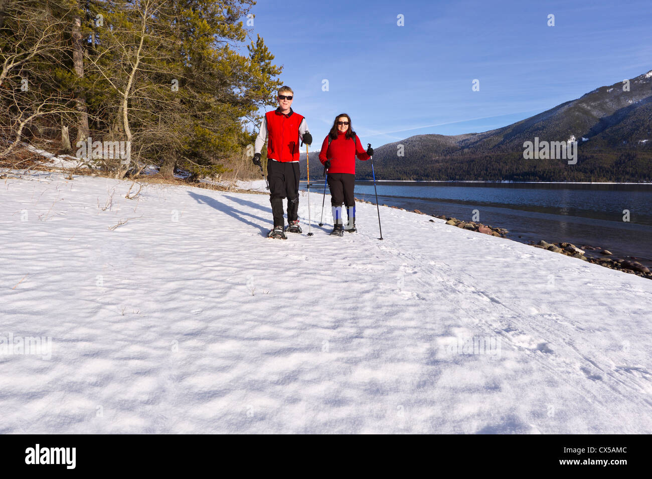 Couple snowshoeing in Glacier National Park, Montana, USA. (MR Stock