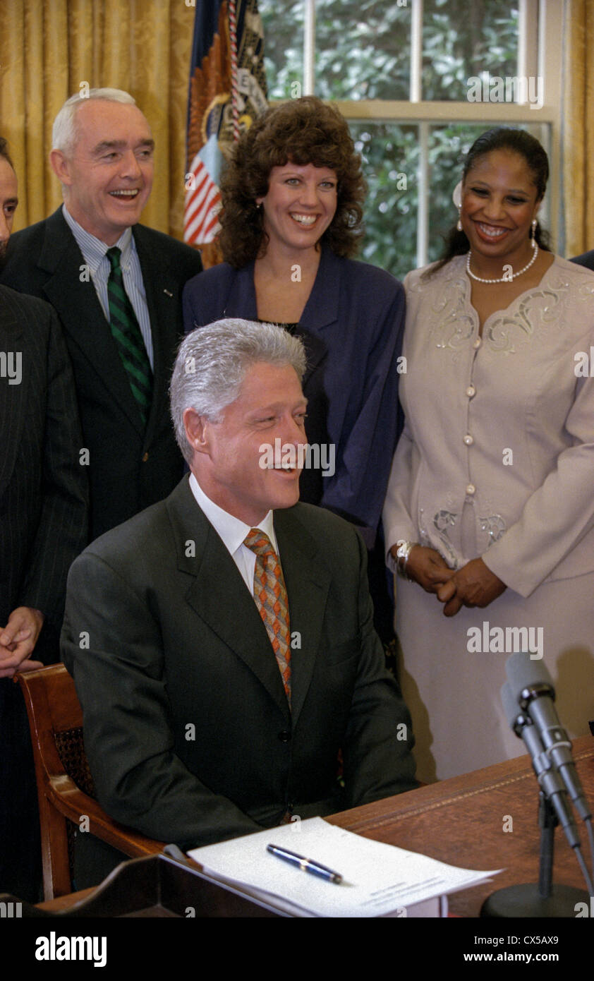 US President Bill Clinton following his weekly radio address in the Oval Office of the White House September 12, 1998 in Washington, DC. The president delivered his radio address on Helping Communities to Keep Kids Drug-Free as US drug czar Barry McCaffrey stands behind along with other leaders. Stock Photo