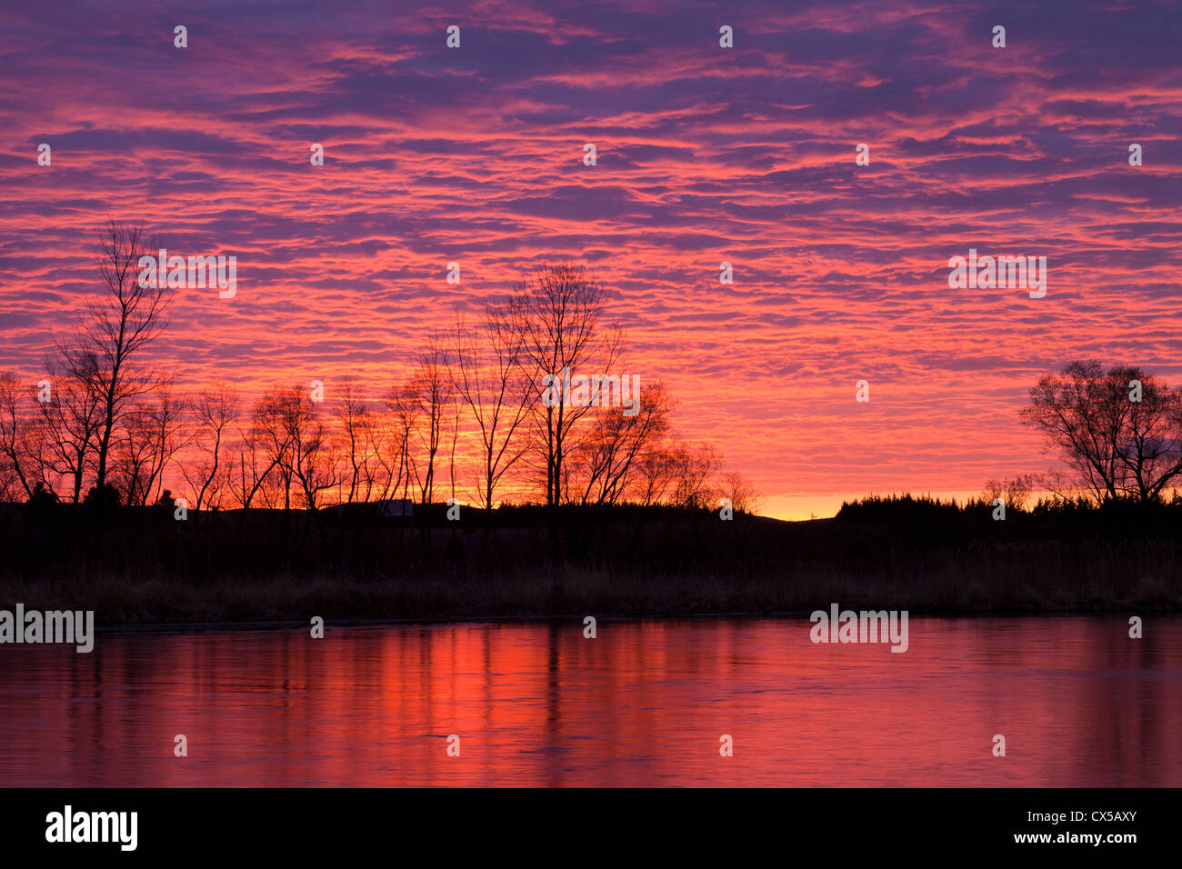 Brilliant sunset reflects into the Calamus River in Loup County