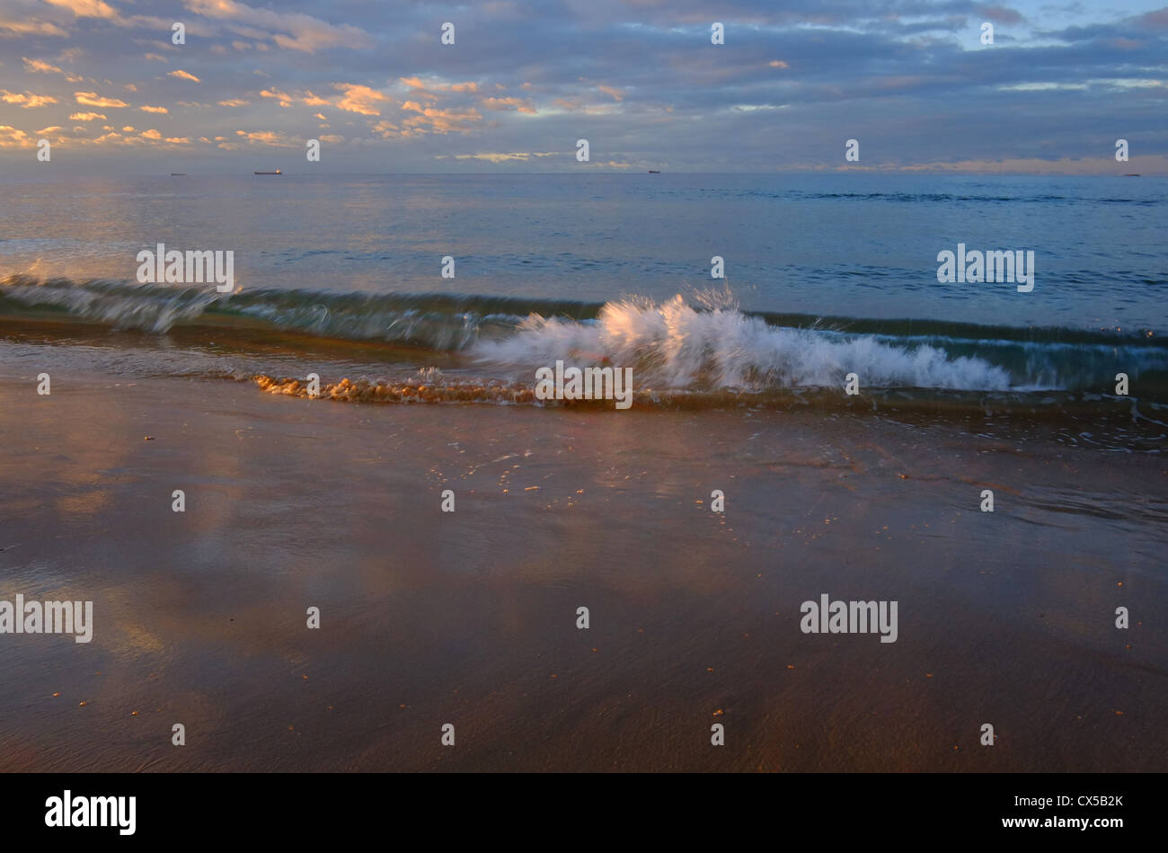 Wave breaking at sunrise, Corrimal beach, NSW Australia Stock Photo