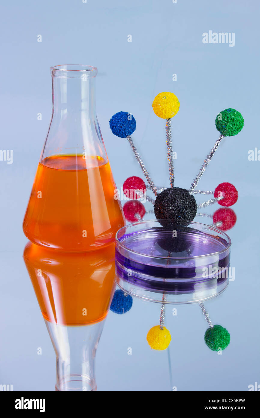 orange flask and purple petri dish with molecular model and reflections Stock Photo