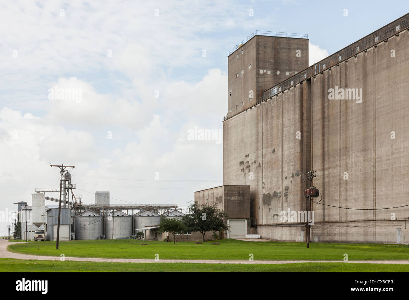 Grain Elevator with rice dryer bins, storage silos and truck loader at