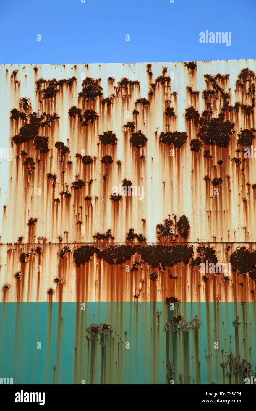 Rusted metal wall with green paint Stock Photo