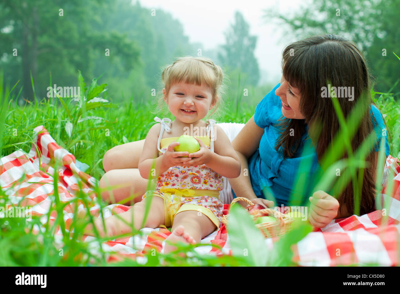 mother and daughter have picnic eating healthy food outdoor Stock Photo