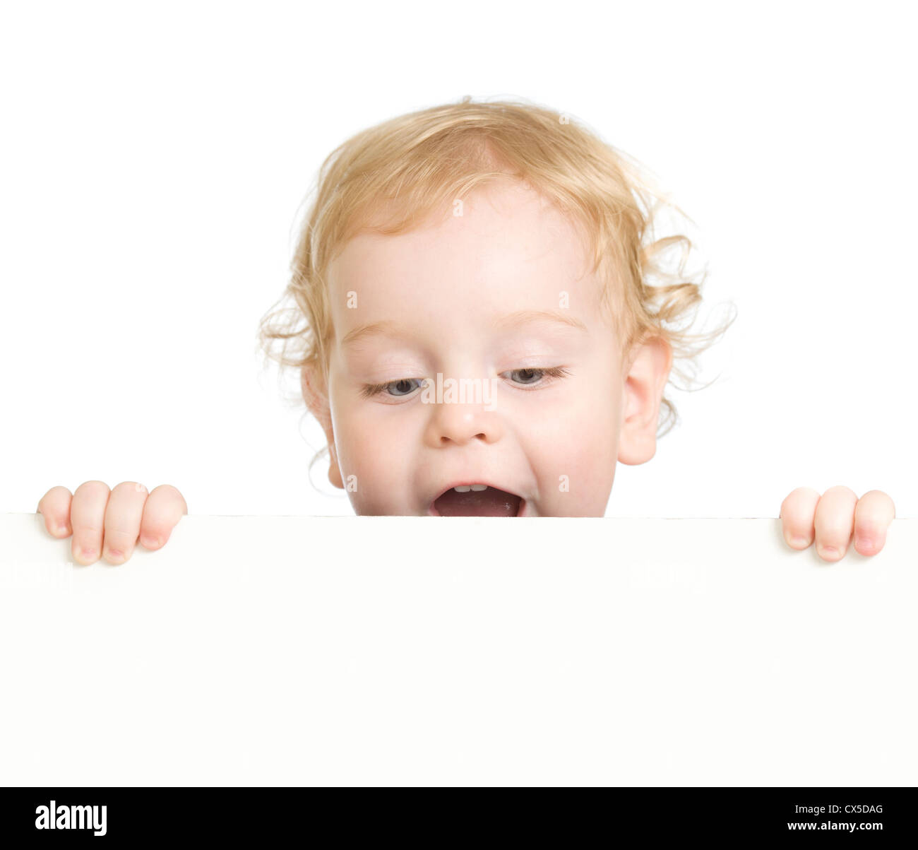 Curly child holding blank advertising banner Stock Photo