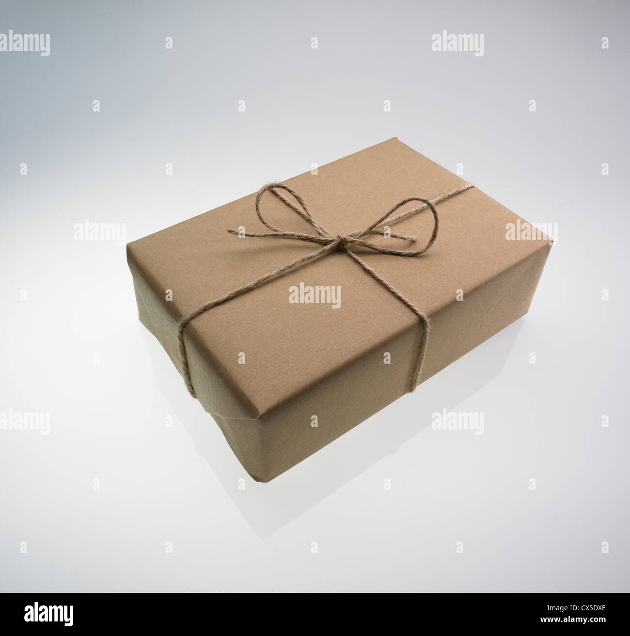 Dark Christmas Background Brown Kraft Paper Parcel Tied With Red And White  String On Black Background Stock Photo - Download Image Now - iStock