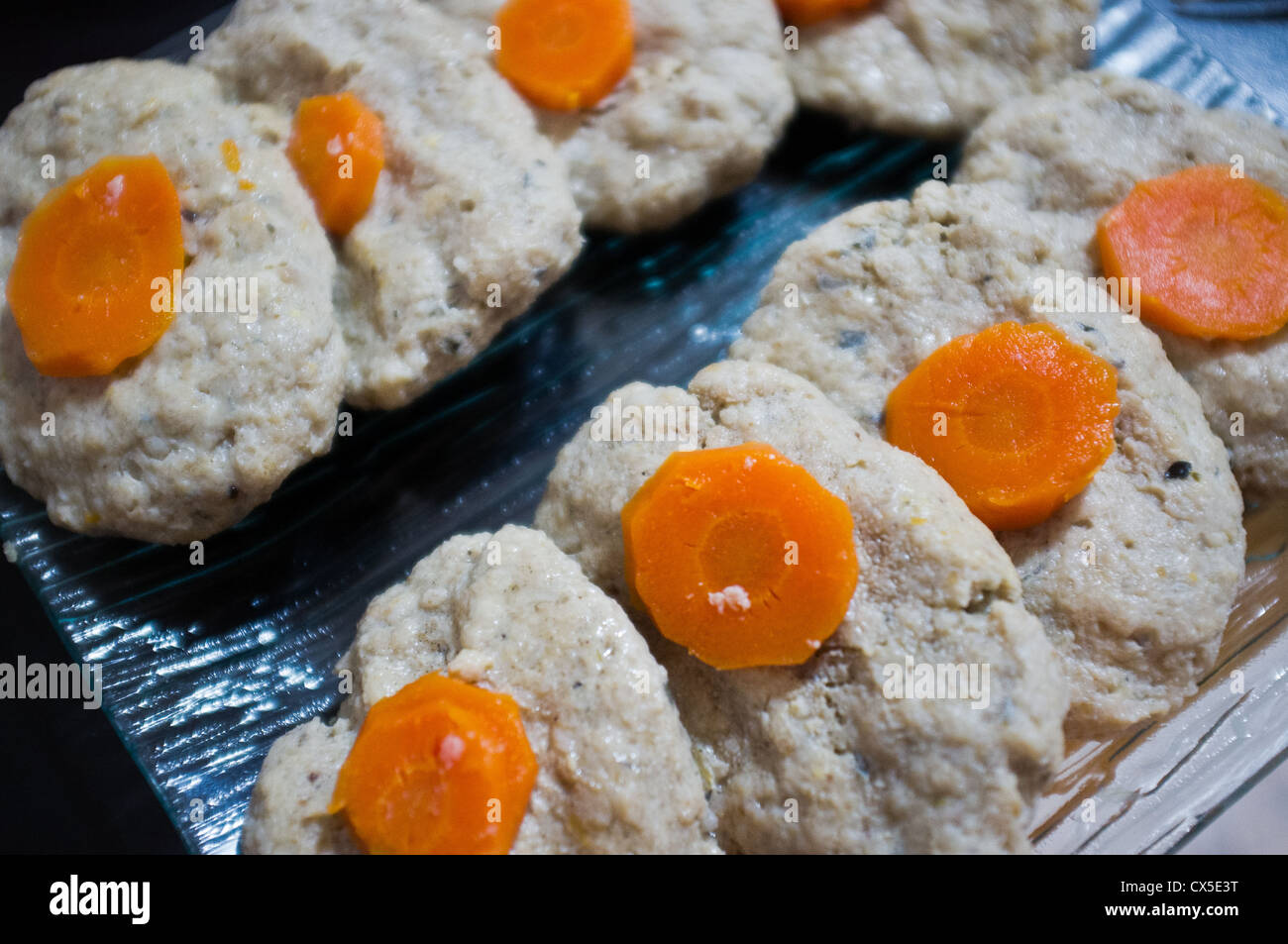 Gefilte Fish patties are traditional Jewish cuisine made of ground carp and served with carrots and horseradish. Stock Photo