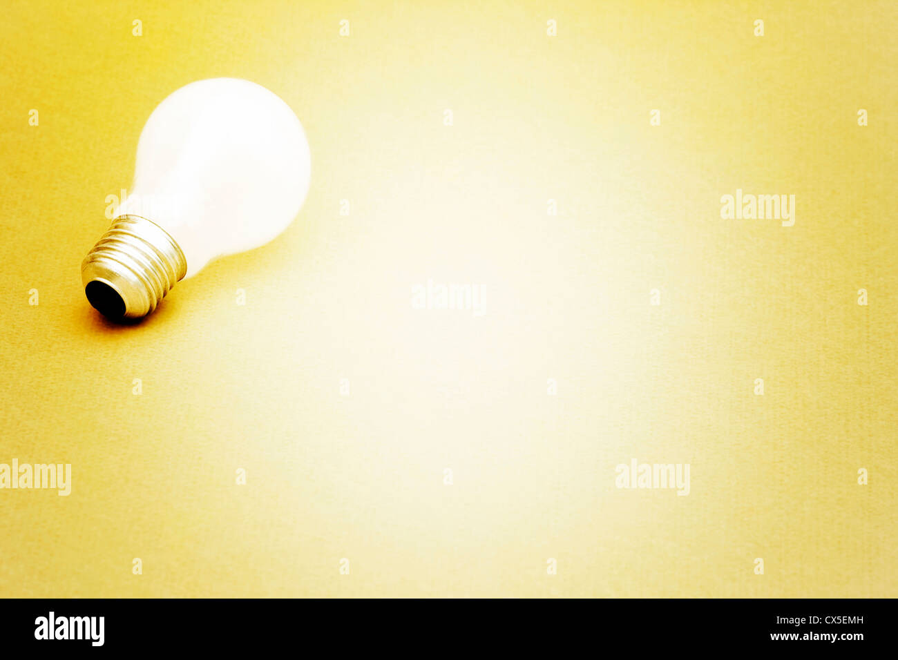Background with lit lightbulb; Isolated on yellow Stock Photo - Alamy