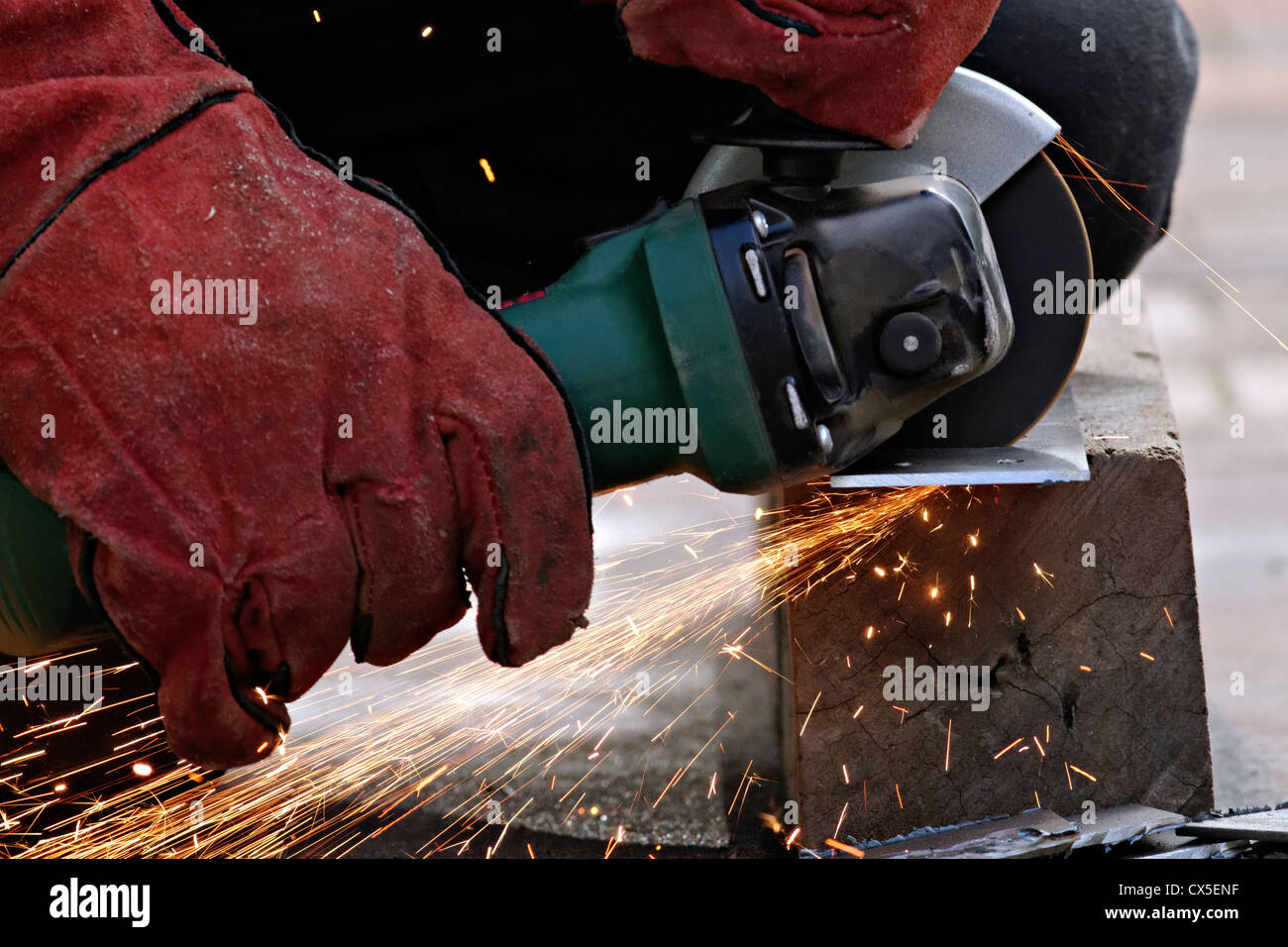 Man cutting metal with a angle grinder Stock Photo
