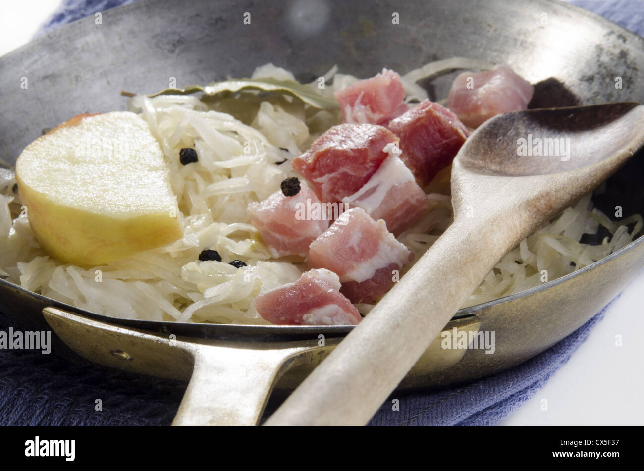 Sauerkraut with diced bacon andapple slice in a pan Stock Photo