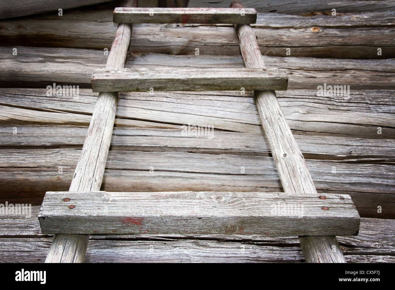Rustic wooden ladder reaching upwards Stock Photo