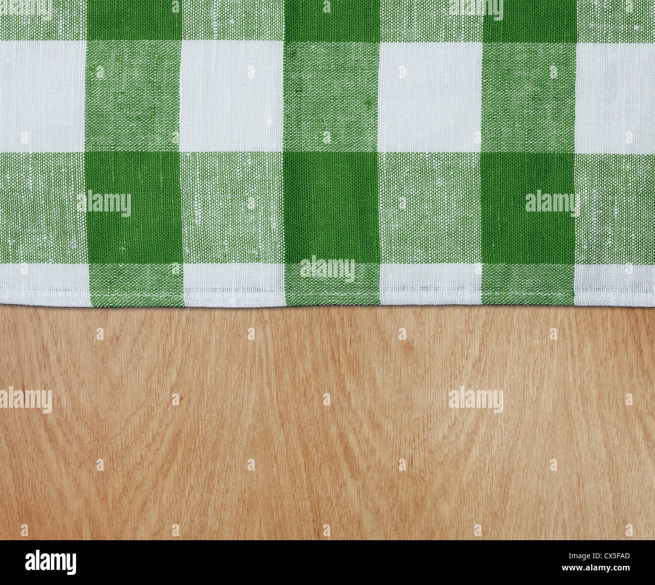 wooden kitchen table with green gingham tablecloth Stock Photo