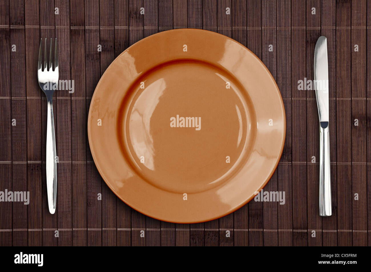Bamboo placemat with plate fork and knife Stock Photo