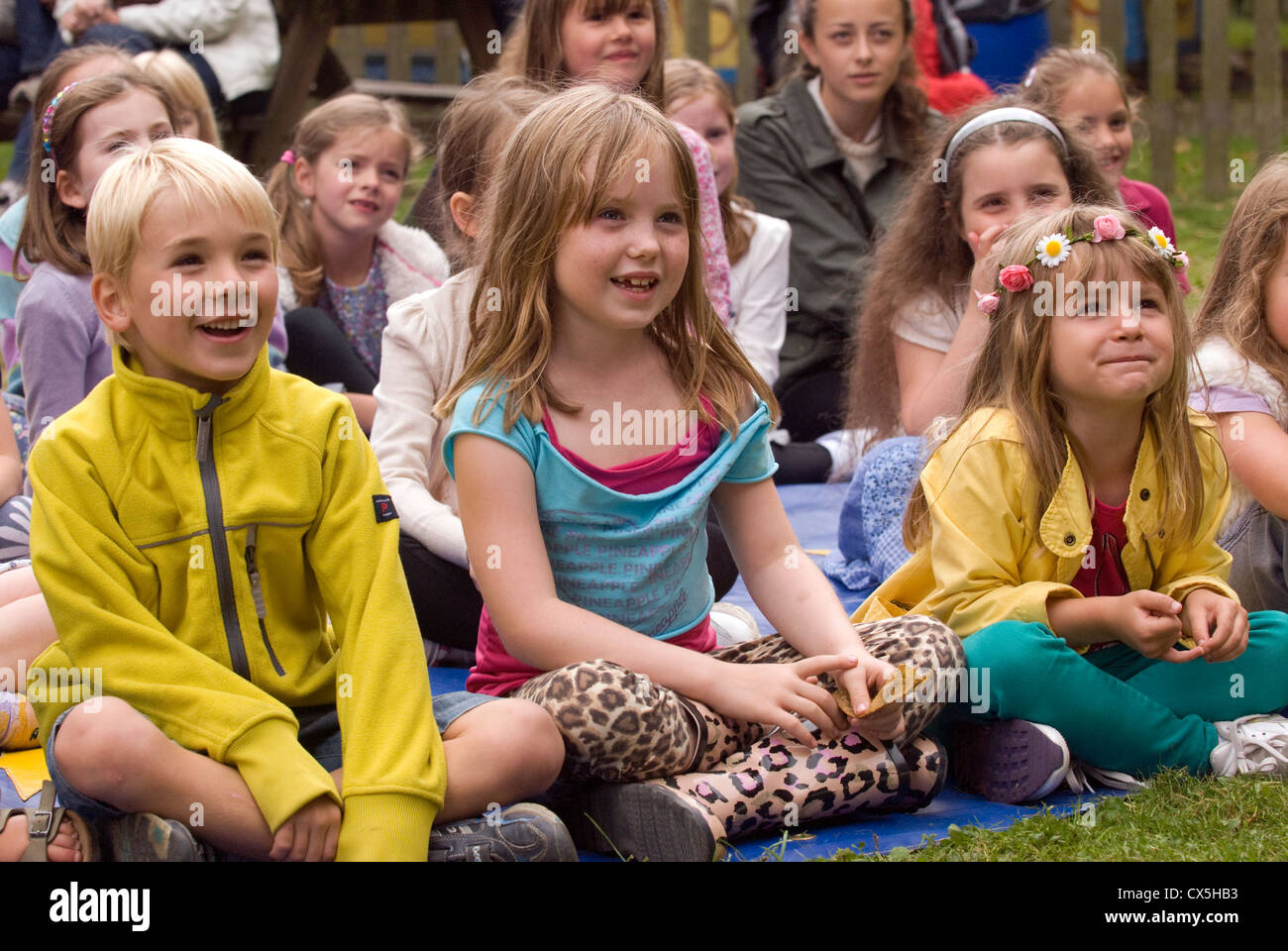 Youngsters being entertained by a clown at a children's outdoor fun day, Liphook, Hampshire, UK. Stock Photo