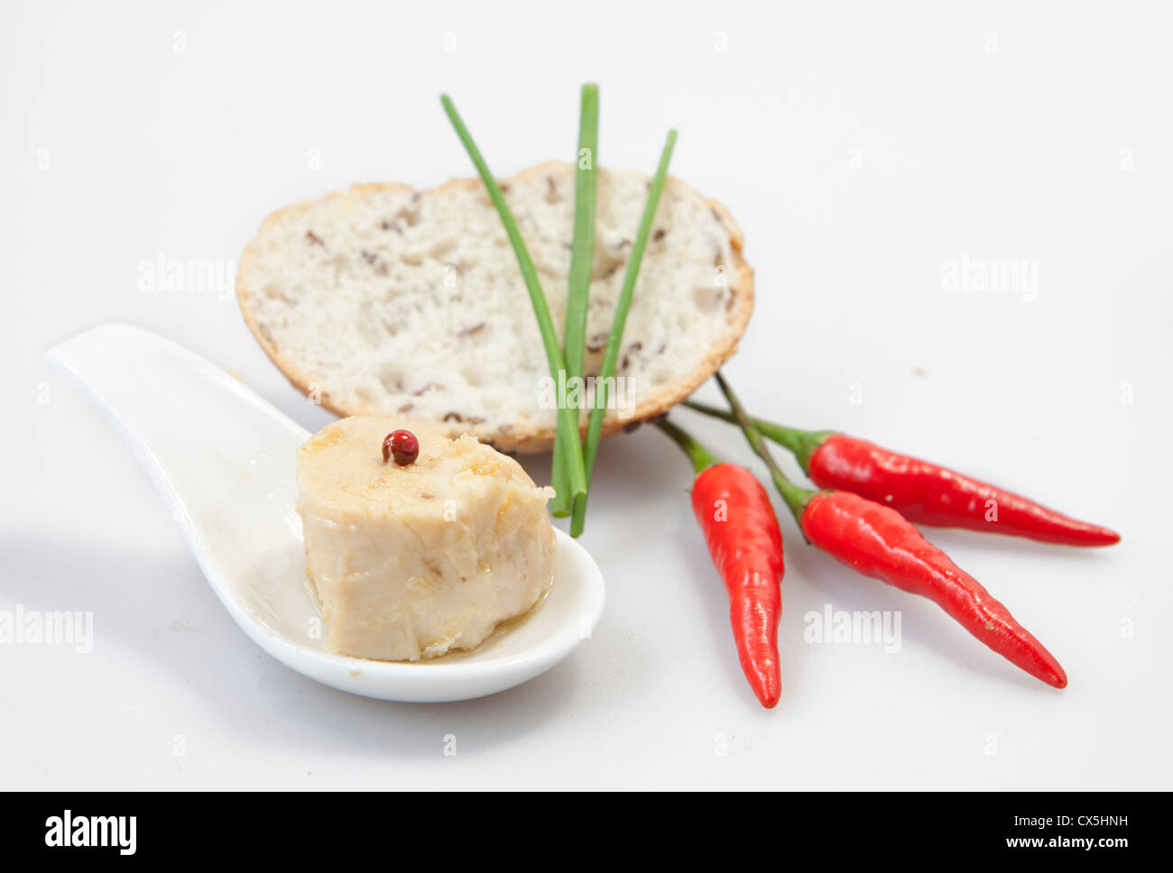 Delicious fresh thuna with red peppers on white background Stock Photo