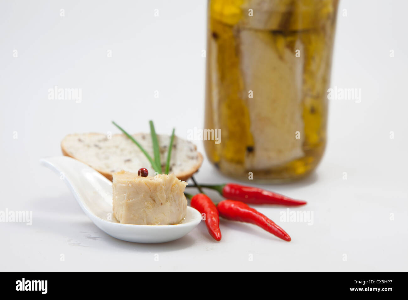 Delicious fresh thuna with red peppers on white background Stock Photo