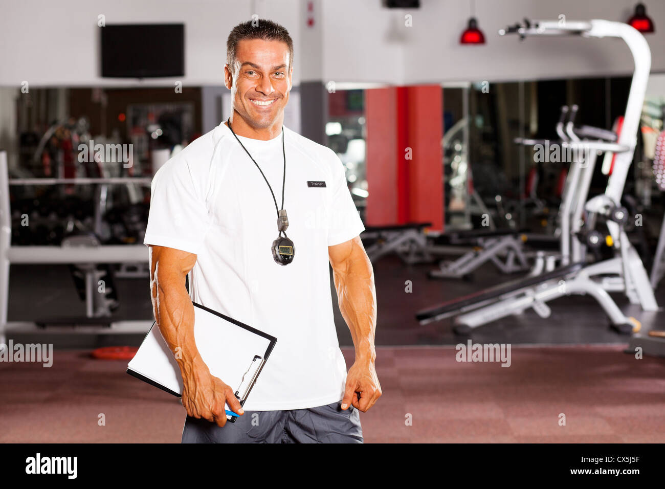 handsome male personal trainer in gym Stock Photo Alamy