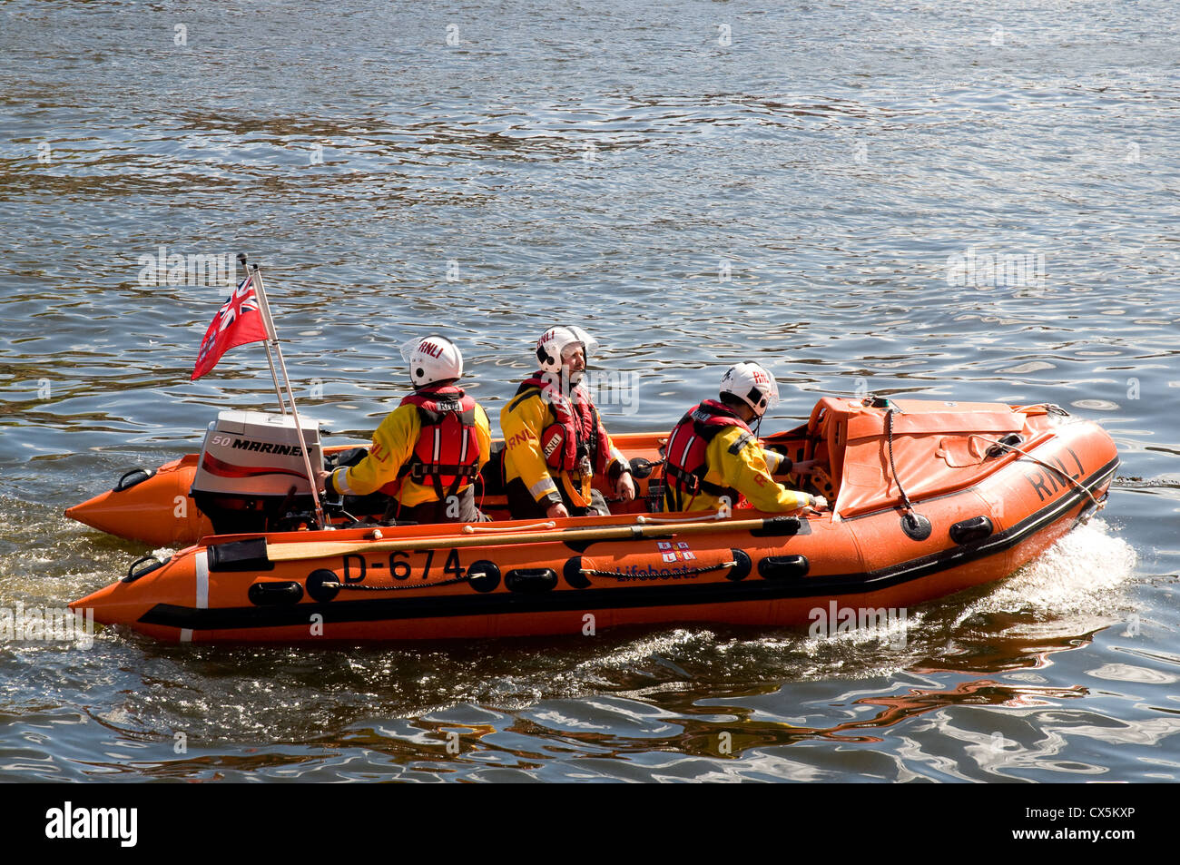 RNLI Inshore lifeboat in Whitby Harbour returning after a shout.  close up of the boat with three crew on board. Stock Photo