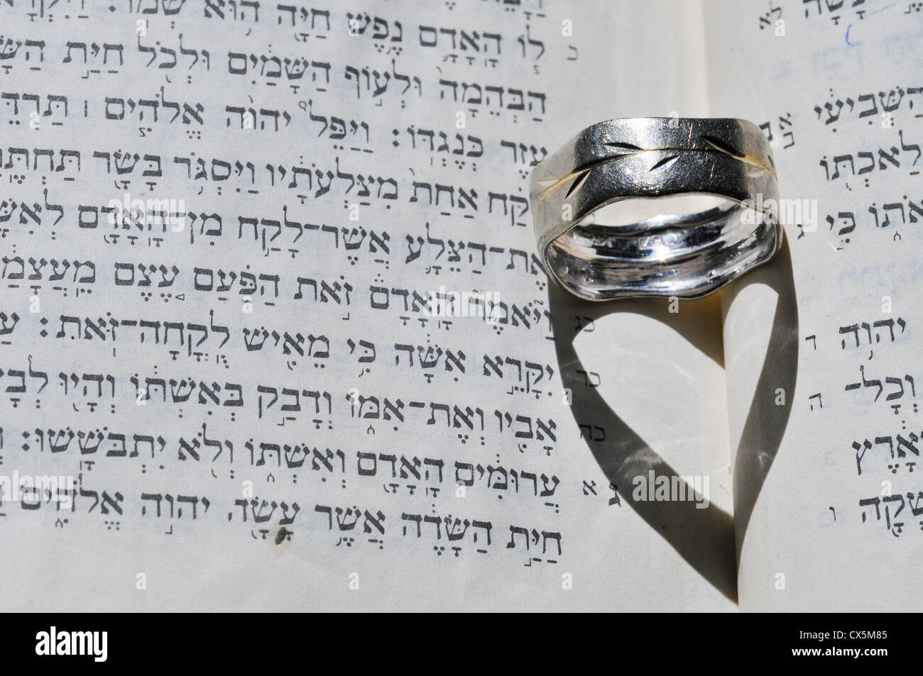 Jewish Wedding concept Wedding ring on Jewish Text (Ketubah)  Stock Photo