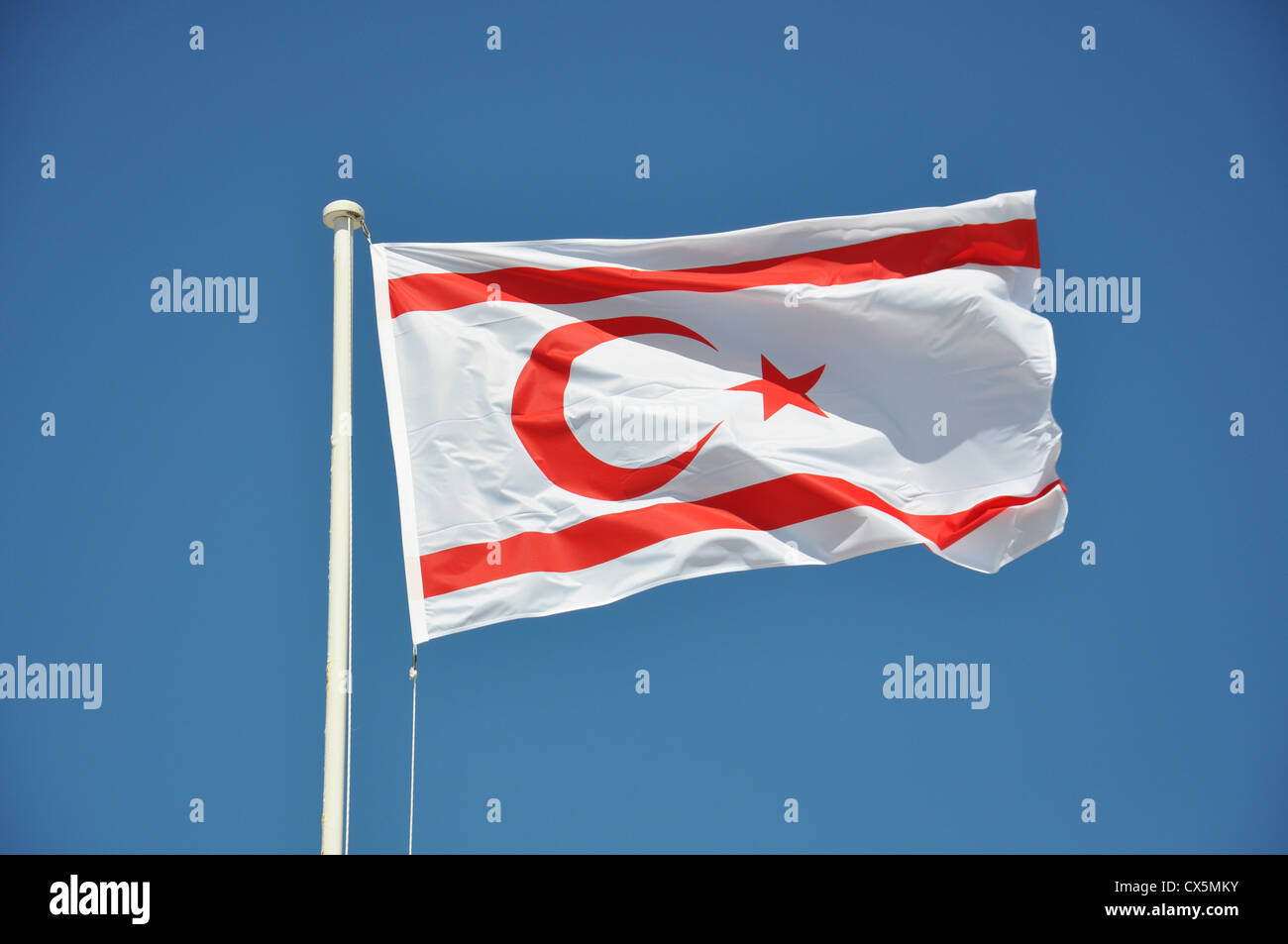 Turkish Republic Of Northern Cyprus (TRNC) flag flying against a blue sky Stock Photo