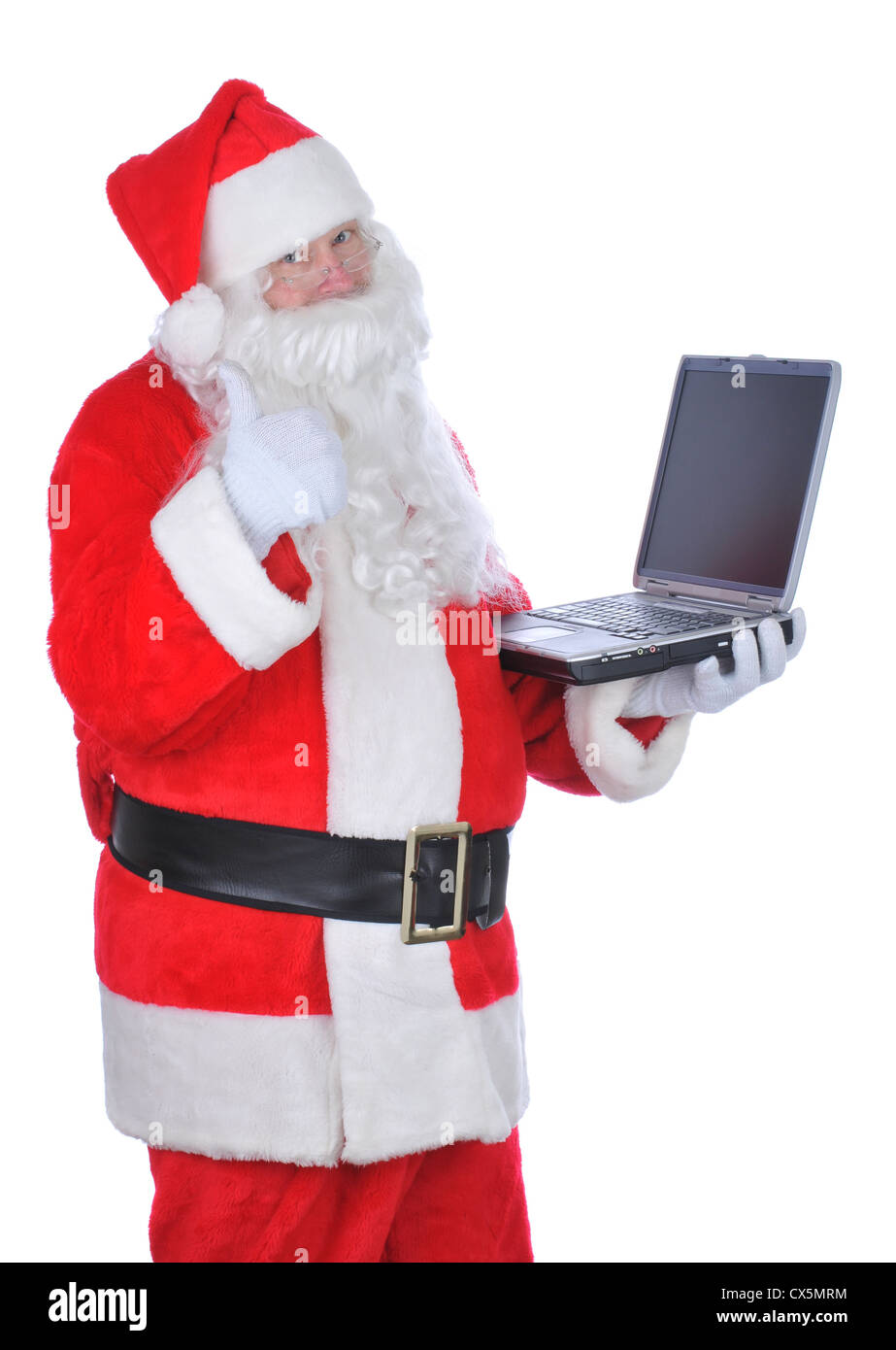 Santa Claus Holding Laptop Giving Thumbs Up sign, isolated over white Stock Photo