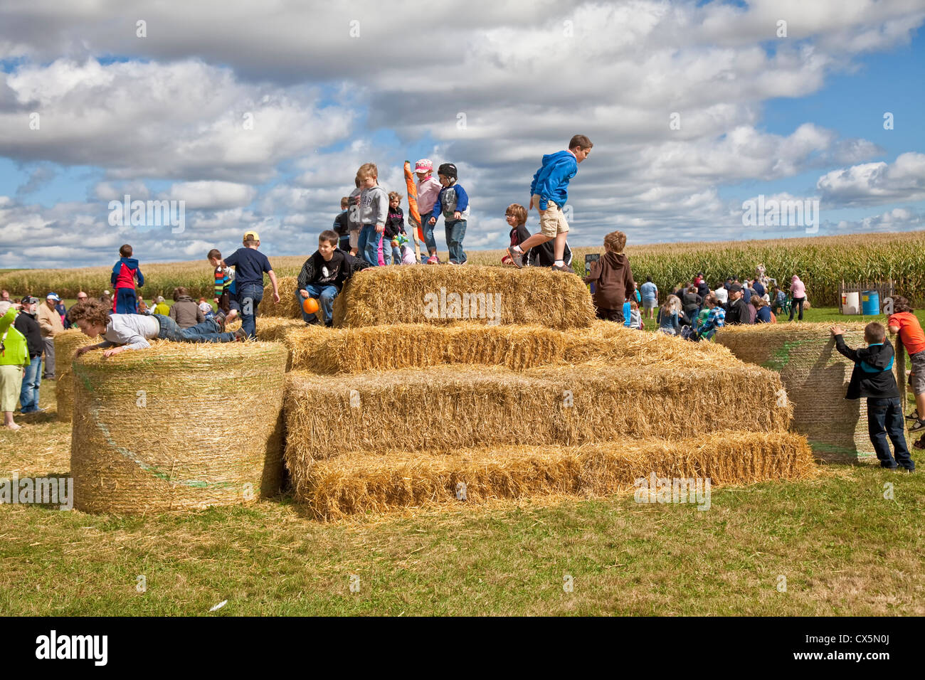 Children climbing and playing on a hay bale mountain at the annual  Scarecrow Festival held in Summerside, Prince Edward Island Stock Photo -  Alamy