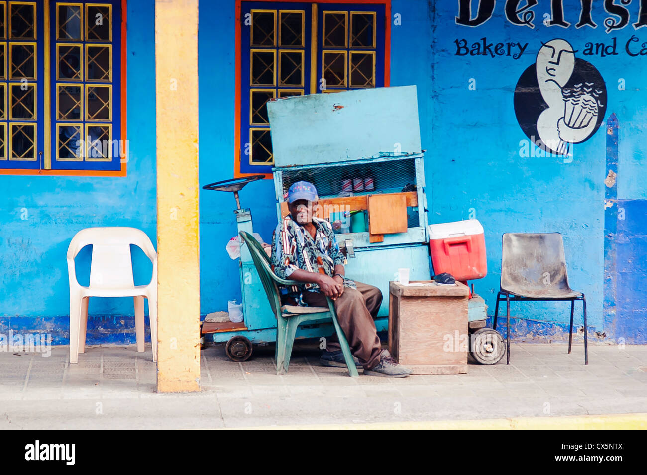 Old black man sitting near bakery, Ocho Rios ,Jamaica, Western Caribbean Stock Photo