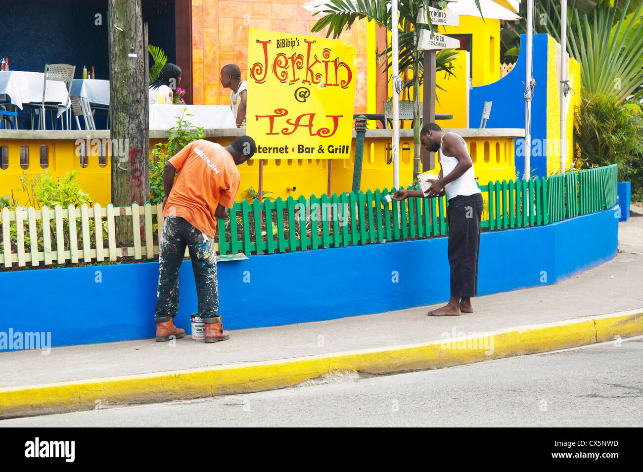 Workers painting wooden fence, Ocho Rios, Jamaica, Western Caribbean