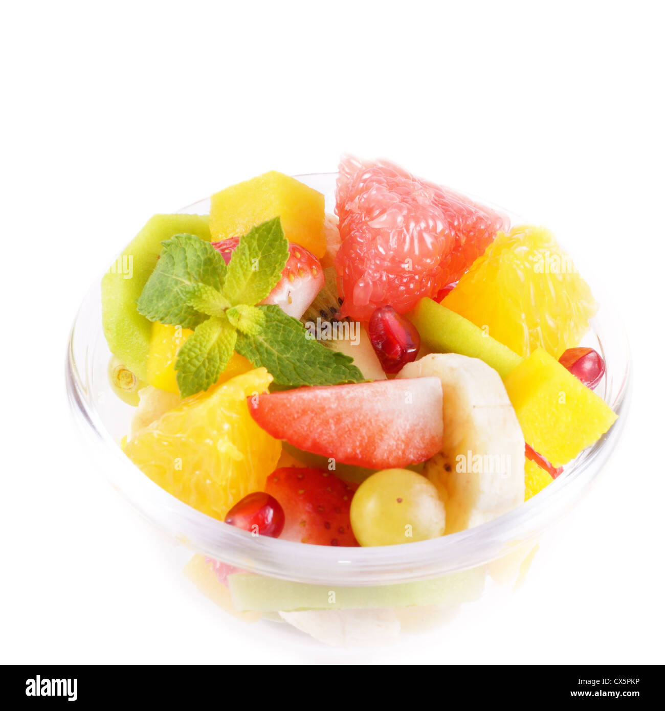 Healthy fruit salad in the glass bowl over white background Stock Photo ...